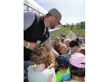 Gärtner Toni erklärt den Kindern, was im Garten wachsen wird.